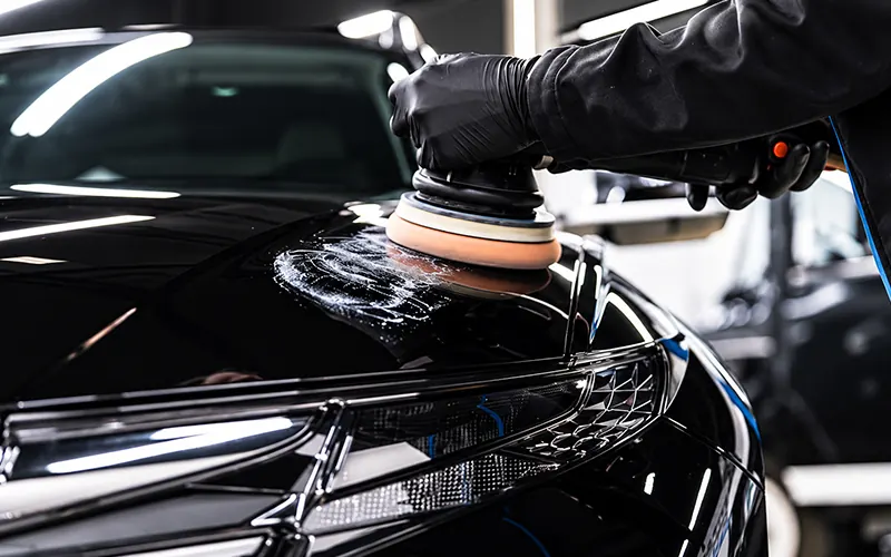 Machine polishing a black car